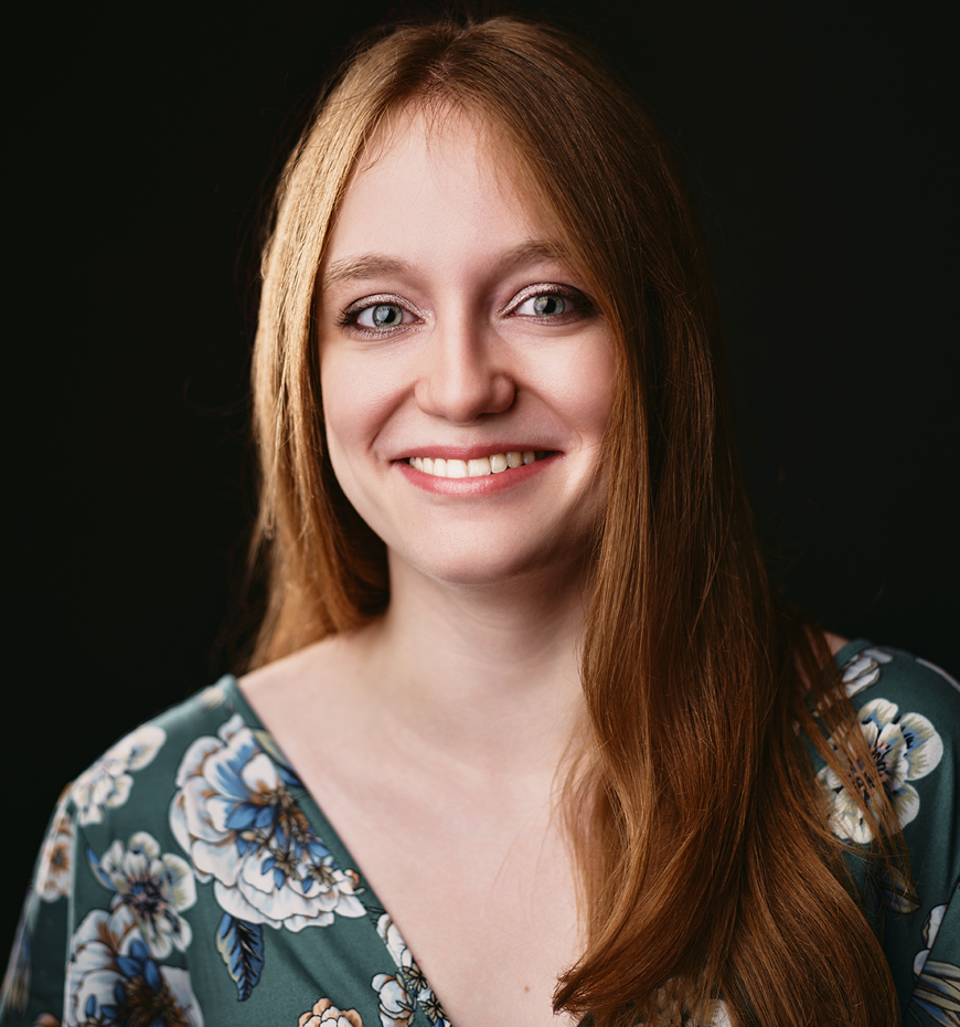 Photo of Omaha Conservatory of Music programming assistant Sofia Cormack smiling at the camera