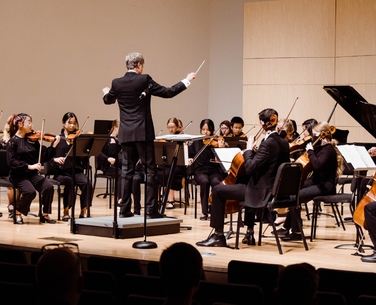 Conductor Ernest Richardson leads an orchestra performance at the Omaha Conservatory.